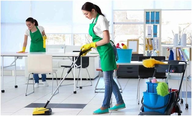 Office cleaning workers with equipment