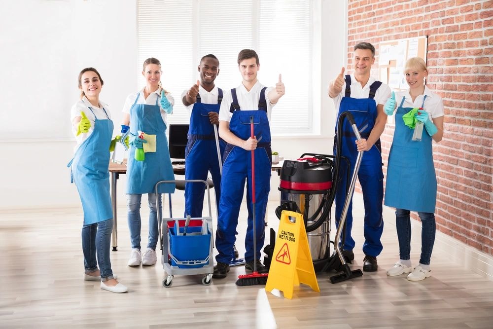 Professional cleaning team posing thumbs up