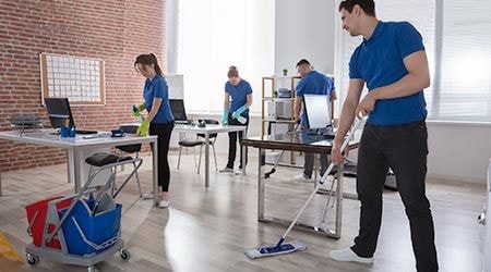 Team cleaning office floor together